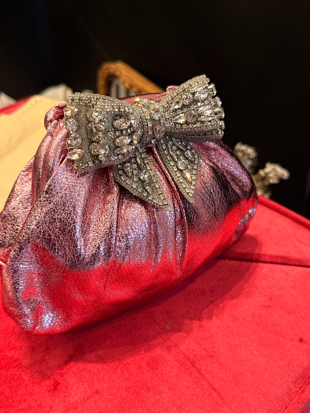 Baby pink clutch with bow embellishments
