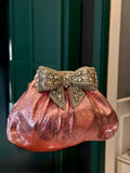 Baby pink clutch with bow embellishments