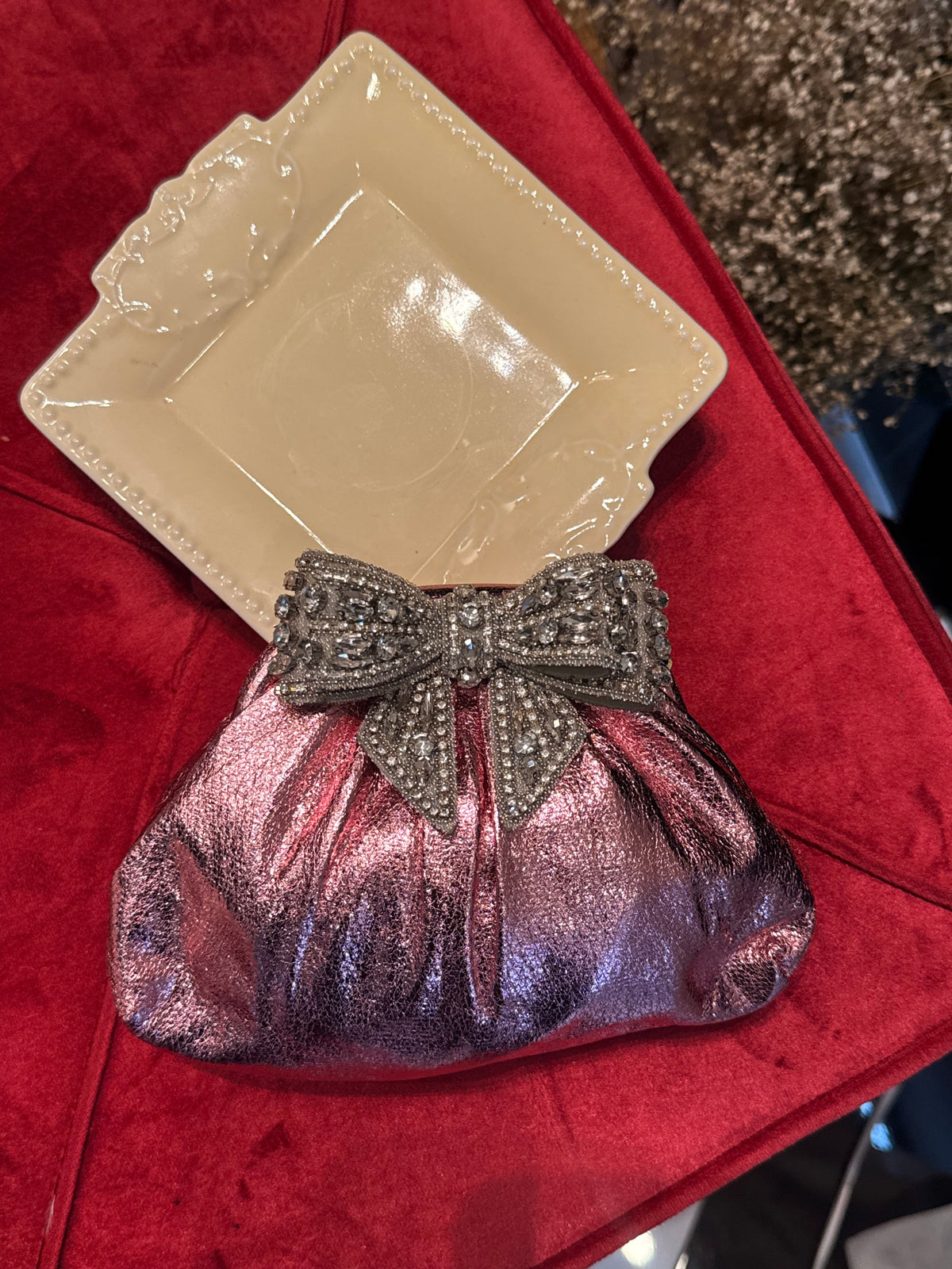 Baby pink clutch with bow embellishments