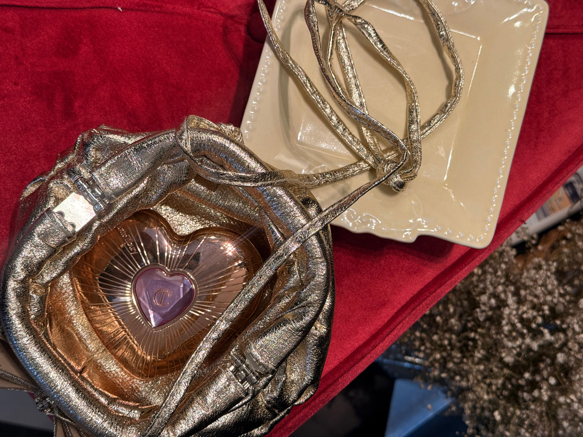Gold leather clutch with bow embellishments
