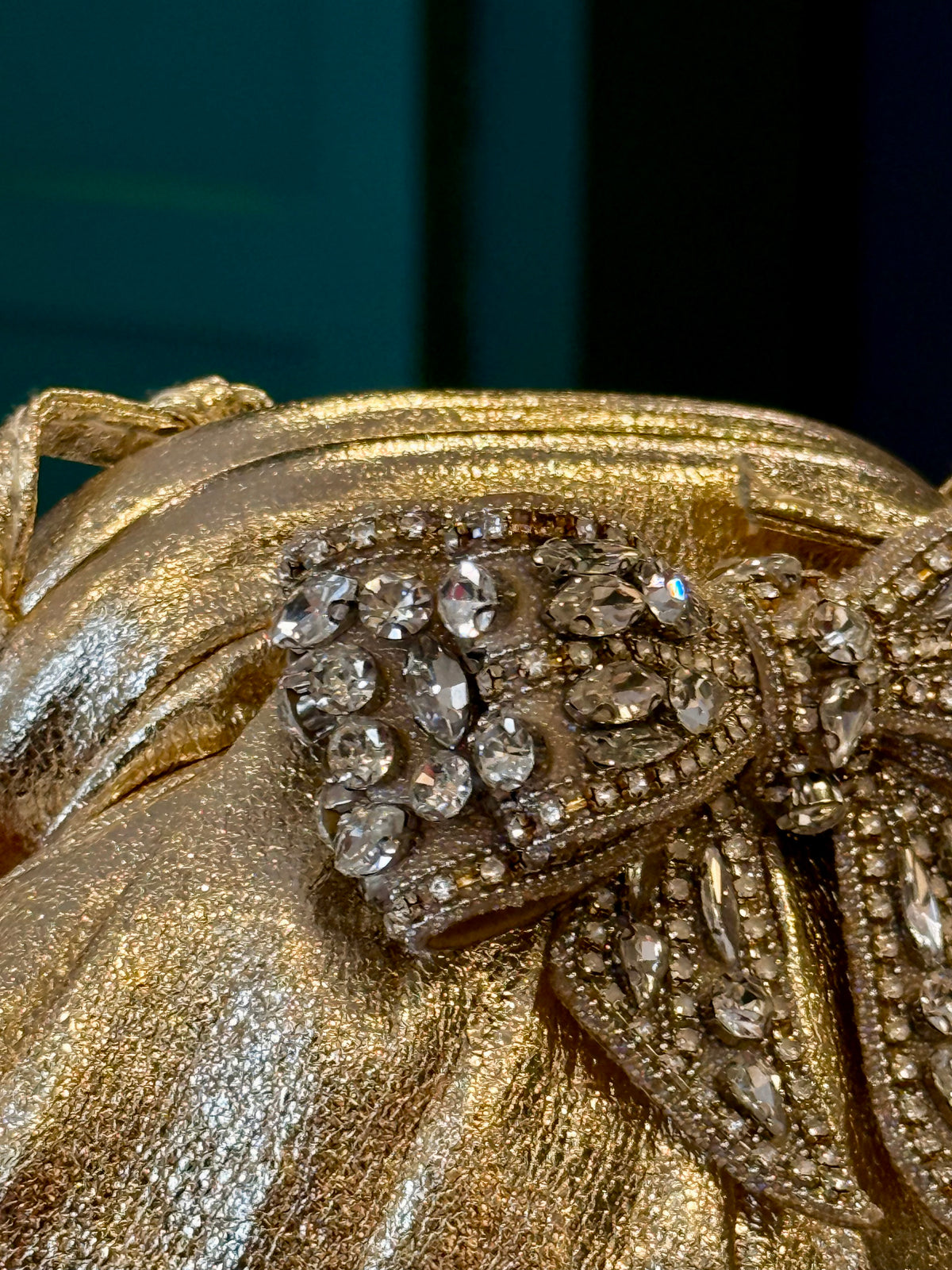 Gold leather clutch with bow embellishments