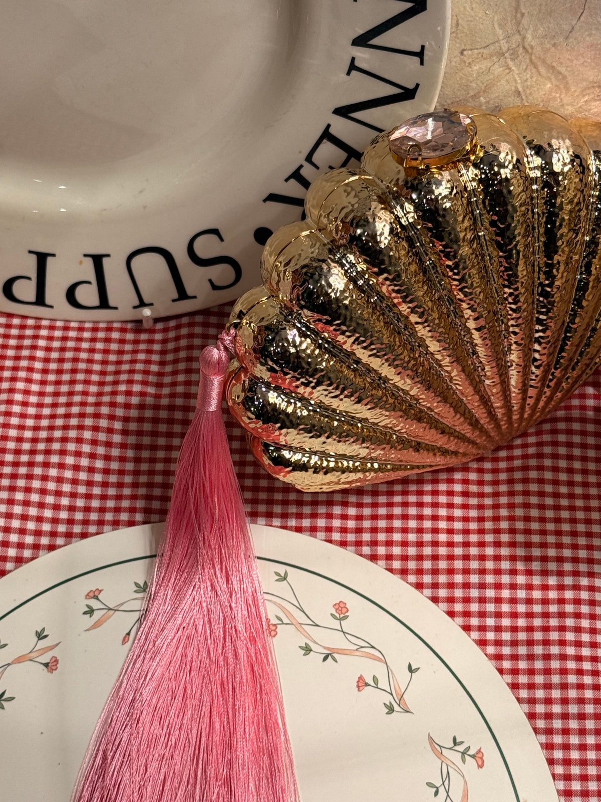 Shell clutch with long pink tassel