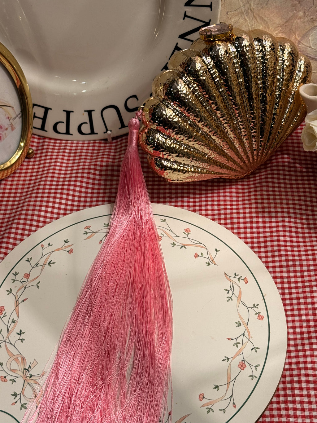 Shell clutch with long pink tassel