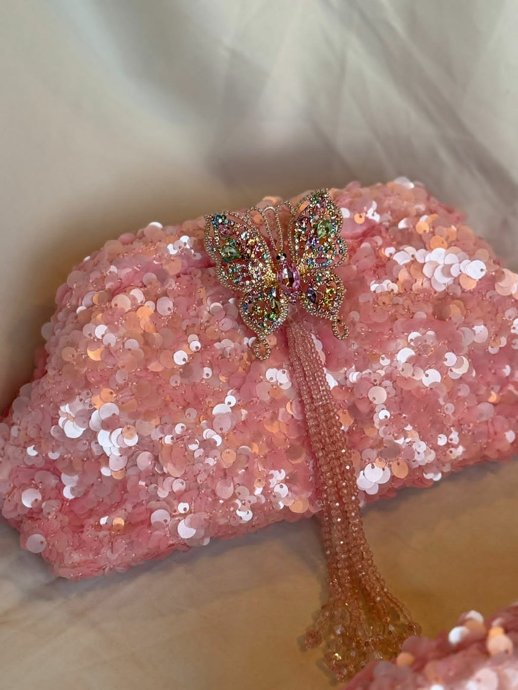 Pink sequin clutch with butterfly