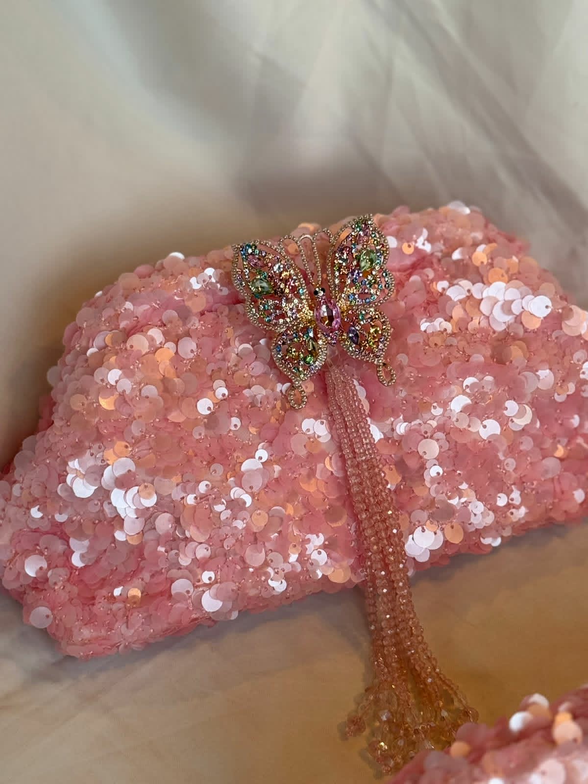Pink sequin clutch with butterfly