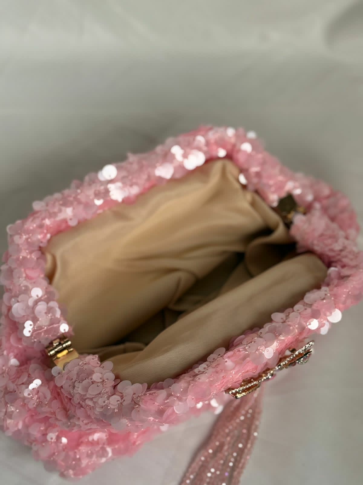 Pink sequin clutch with butterfly