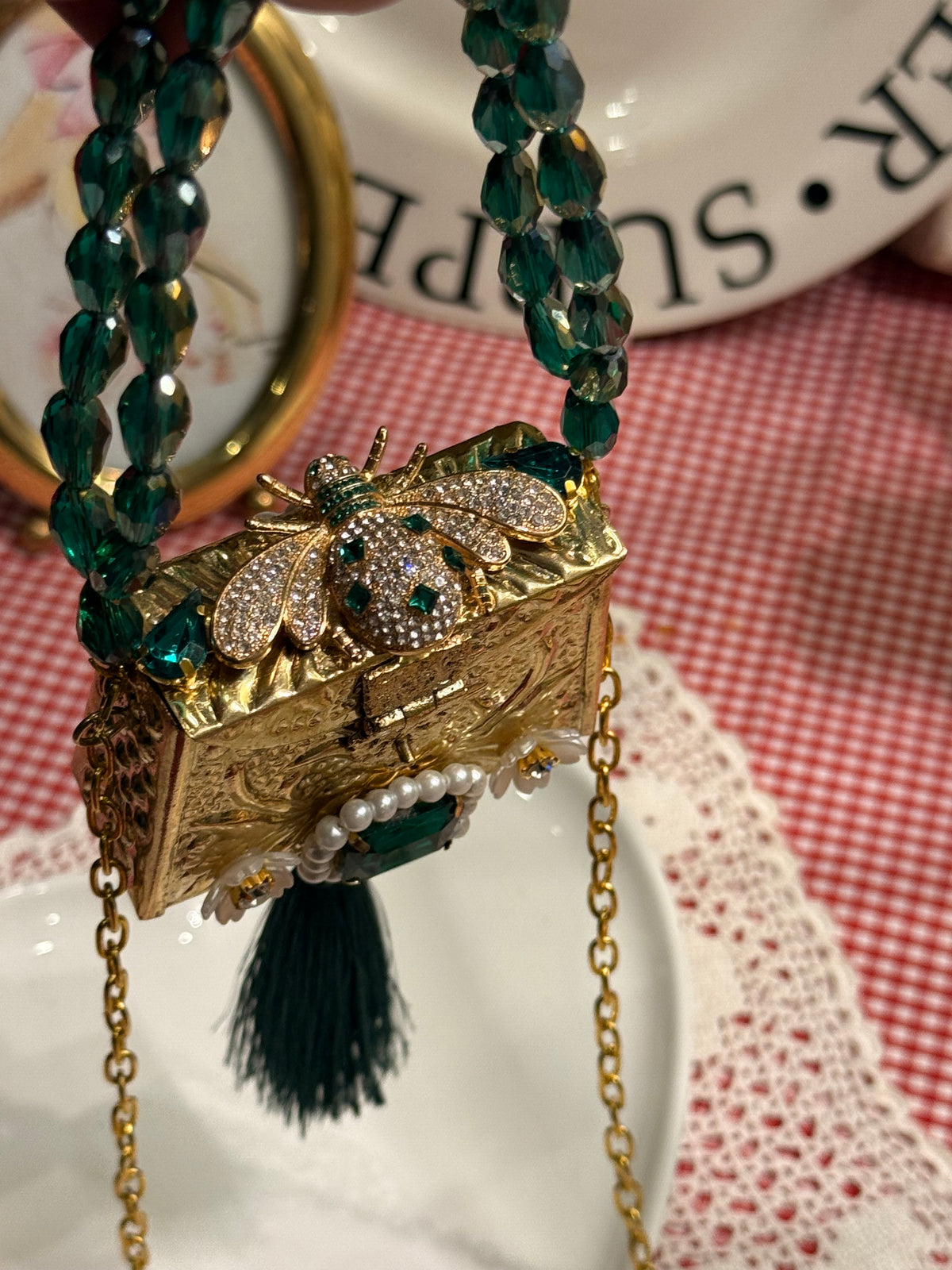 Green bug clutch with tassel