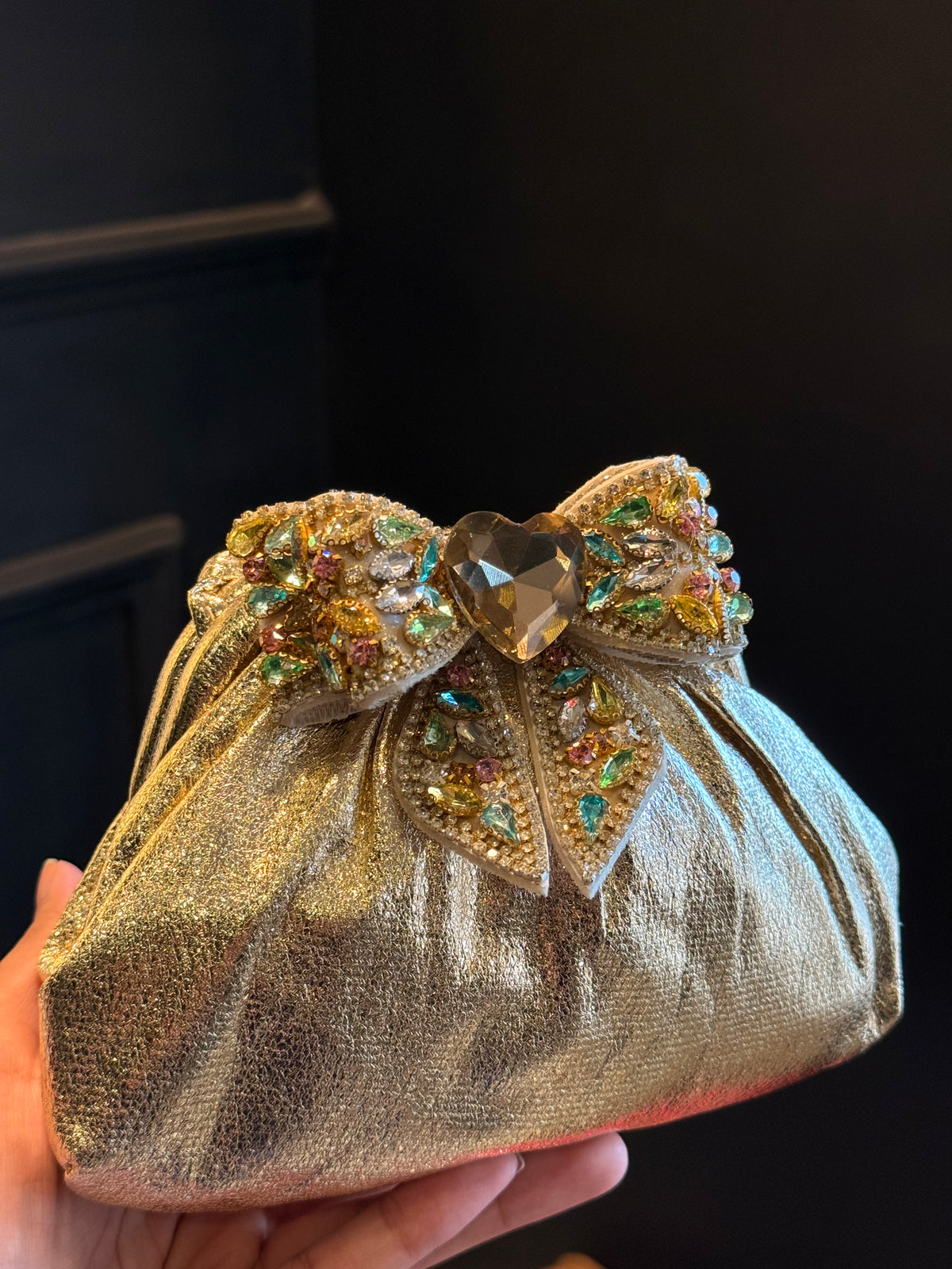 Gold clutch with multi colour bow
