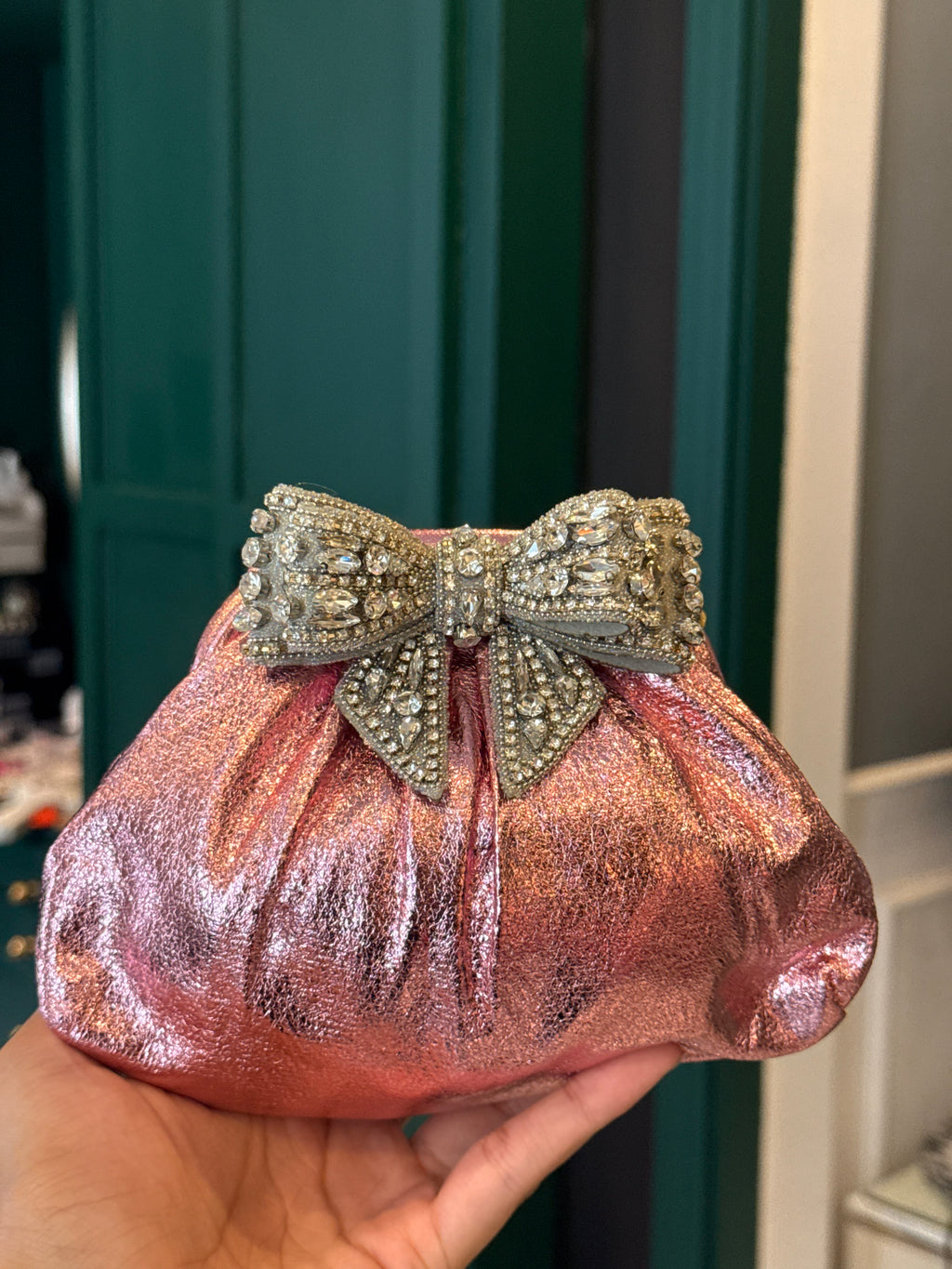 Baby pink clutch with bow embellishments