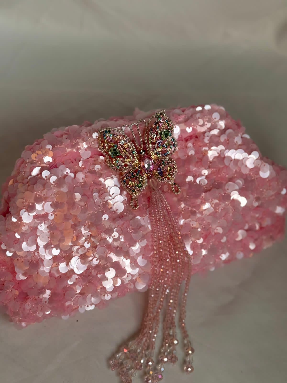 Pink sequin clutch with butterfly