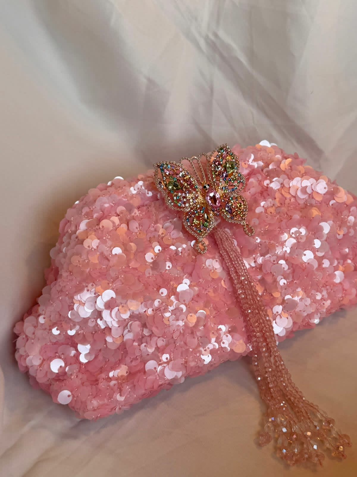 Pink sequin clutch with butterfly